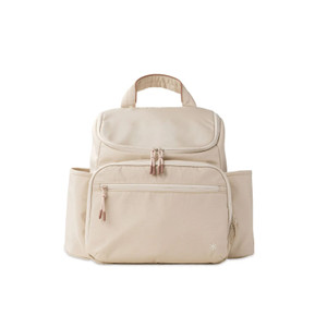 Skip Hop Forma beige nappy backpack with multiple pockets and rose gold zippers on white background