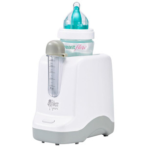 The First Years white bottle warmer with teal baby bottle and clear measurement chamber on grey base