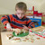 Close-up of Melissa & Doug Pizza Party wooden pizza with Velcro toppings ready to cut