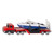 SIKU red low loader truck and trailer carrying navy blue and white speedboat, left side view showing boat secured by cradle supports and fold-down rear ramp