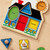 Toddler placing wooden triangle shape into Melissa and Doug knob puzzle board