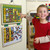 Child placing magnetic checkmark on Melissa and Doug responsibility chart