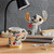 Disney by Britto Midas Stitch figurine holding red flower with mug on desk in styled setting