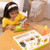Child building pretend nachos with Melissa and Doug Wooden Nachos Play Set