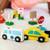 Child setting up wooden traffic signs for road play with Melissa and Doug vehicles