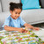 Orchard Toys Snakes and Ladders Game in play showing children counting spaces on board
