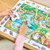 Orchard Toys Peter Rabbit Jigsaw in play showing child assembling 50-piece puzzle