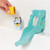 Toomies Bluey bath toy with turquoise waterslide, blue Bluey figure and yellow cup pouring water demonstration