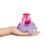 Hand holding Doctor Squish Mini Squishy Maker with pink confetti-filled squishy on purple arched base