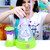 Woman pulling stretchy purple slime from the Doctor Squish maker dome on a white table