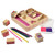 Melissa & Doug Friendship Stamp Set - angled view of wooden box with purple-painted interior compartments, scattered stamps and open 2-colour inkpad | Peekaboobaby