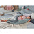 Woman resting on green-grey Theraline maternity and nursing pillow in modern bedroom