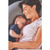 Woman resting on mid-grey Theraline Original maternity and nursing pillow in contemporary bedroom
