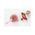 Grey Beaba silicone spoon with food in white bowl, surrounded by fresh berries