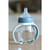 Beaba bottle with blue nipple top and white handles, lifestyle shot