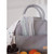 Grey fabric storage basket with Beaba spoons and fresh fruit, lifestyle shot