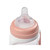 Overhead close-up of Beaba vintage pink bottle top showing nipple cap and conversion ring