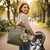 Woman wearing nappy bag with Jamie the Bunny keychain attached in park