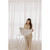 Woman holding Bubble Baby Bathtub basin, assembled, white curtain backdrop