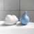 Child squeezing Ubbi white cloud bath toy underwater