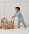 Toddler wearing ergoPouch Dragonflies print sleep onesie while playing with a toy stroller