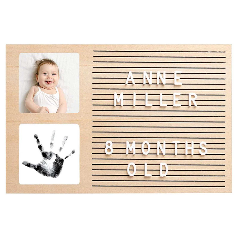 Pearhead letterboard frame in oak with white letters spelling Annie Miller 8 months old, baby photo and black handprint