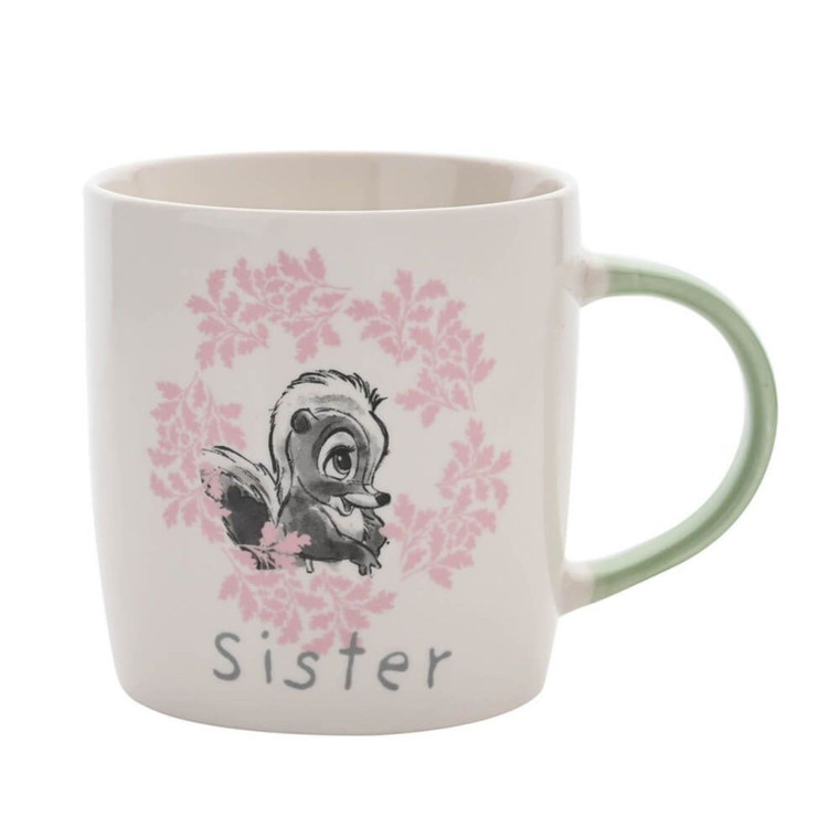 Disney Bambi white ceramic mug with pink floral wreath, Flower character illustration and 'Sister' text, featuring a green
