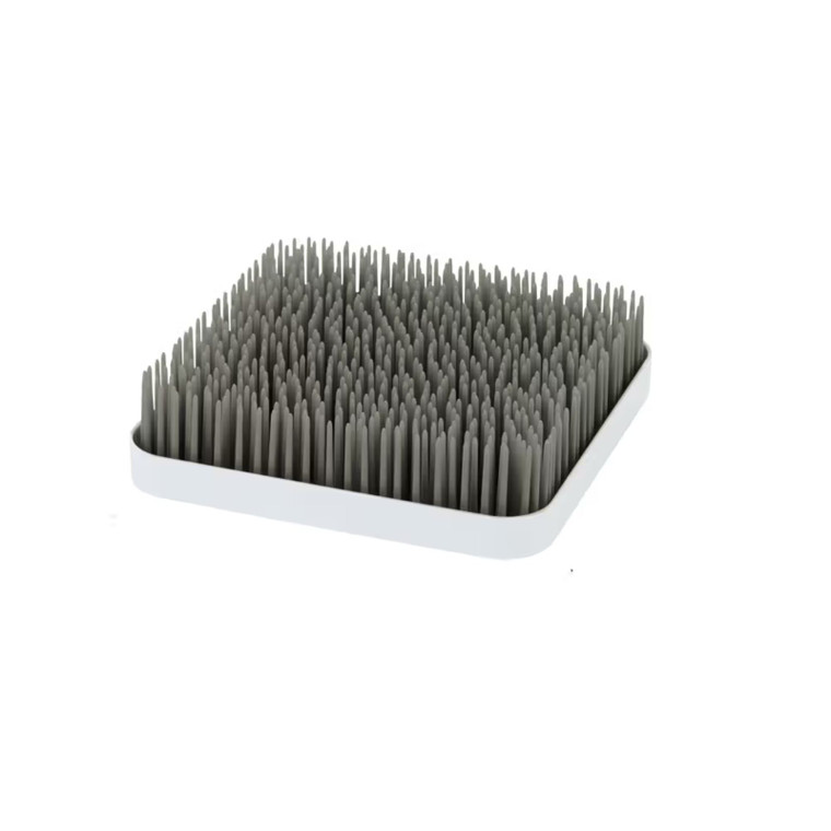 Boon grey countertop drying rack with grass-like silicone blades on white tray base against white background