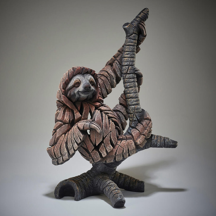 Edge Sculpture sloth figurine in bronze and grey tones, crafted from interlocking geometric pieces, hanging from branch