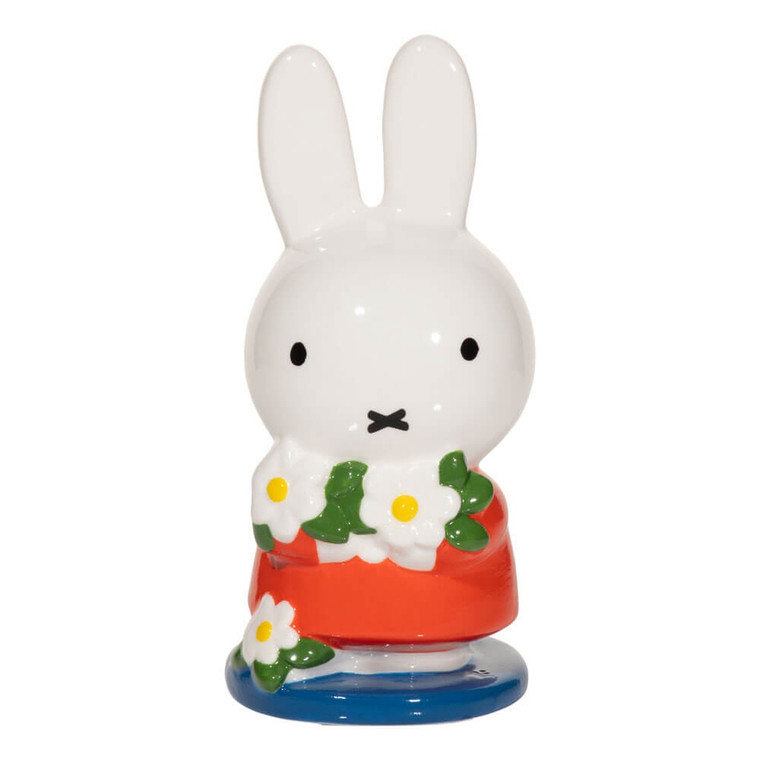 Ceramic Miffy figurine in a red dress holding white daisies on a blue base by Dick Bruna
