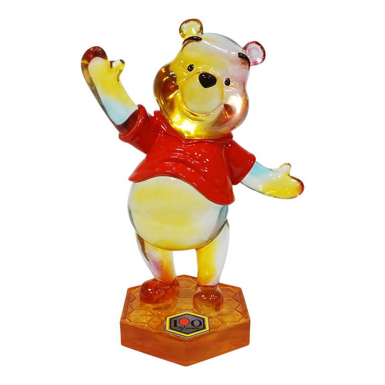 Winnie The Pooh 100th Anniversary Rainbow Numbered Limited Edition Figurine - crystal-clear Pooh figurine with rainbow gradient in red shirt, waving arm raised | Peekaboobaby