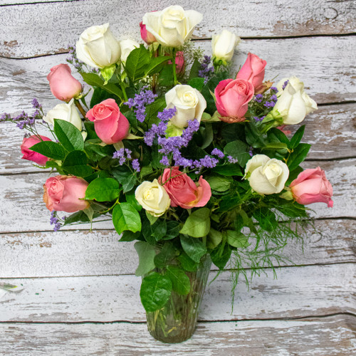 This expressive arrangement includes TWO dozen long stem fresh cut premium pink and white roses with complementary filler flowers.