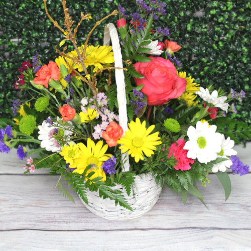 Bright mixed flowers in a wicker basket