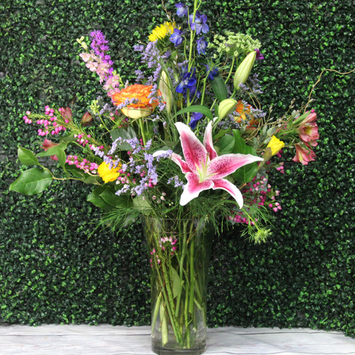 Sunflowers, lilies, and roses arranged in a vase