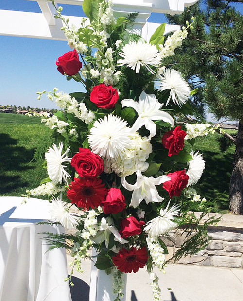 Custom Designed wedding spray with a variety of red and white fresh flowers. Bold red gerberas  were the focus flower of this Loveland Wedding!
