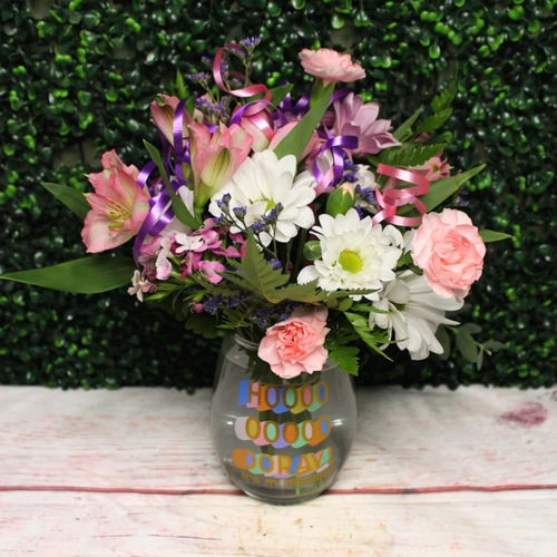 Fresh birthday flowers in an oversized stemmed glas