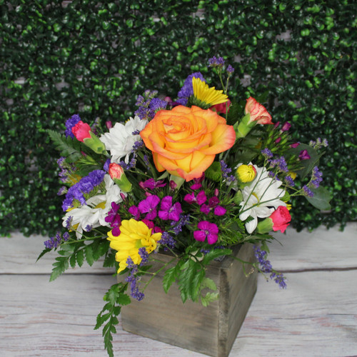 Colorful flower arrangement in a wood box