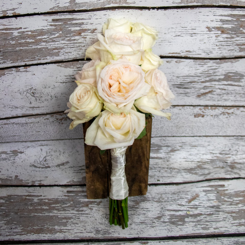 A bridal bouquet of all beautiful white garden roses designed in a vertical nosegay style. 

