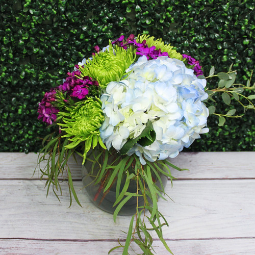 Hydrangea and accent flowers arranged in a vase