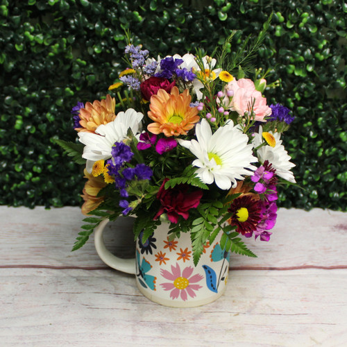 Another example of the Perfect Posies Mug arrangement with white daisies, pink and burgundy carnations, and purple statice in a floral printed mug.