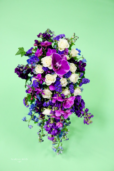 Love purple, you need this in stock, delphinium,  fabulous butterfly orchids and
the perfect touch of white roses.