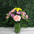 Pink carnations, purple daisies, and yellow alstroemeria with lavender statice in a vase