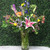 Sunflowers, lilies, and roses arranged in a vase