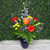Blue delphinium with bright roses, carnations, and alstroemeria in a blue vase