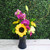 Orchids and mixed flowers arranged in a vase
