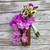 A cascading bouquet of beautiful pink and purple phalaenopsis orchids with white and purple calla lilies.