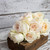 A bridal bouquet of all beautiful white garden roses designed in a vertical nosegay style.