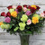 Four dozen mixed color roses arranged in a vase