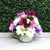 Daisies and carnations arranged in a coffee mug