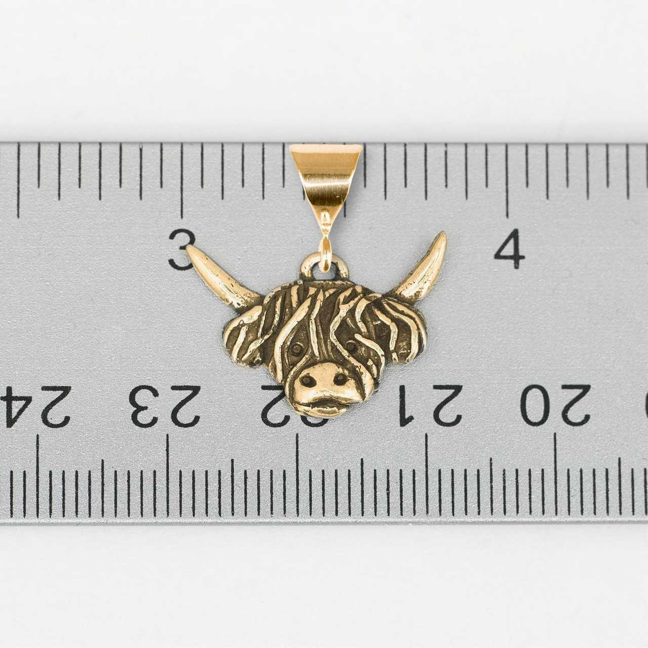 gold highland cow pendant on ruler 97094.1658176699